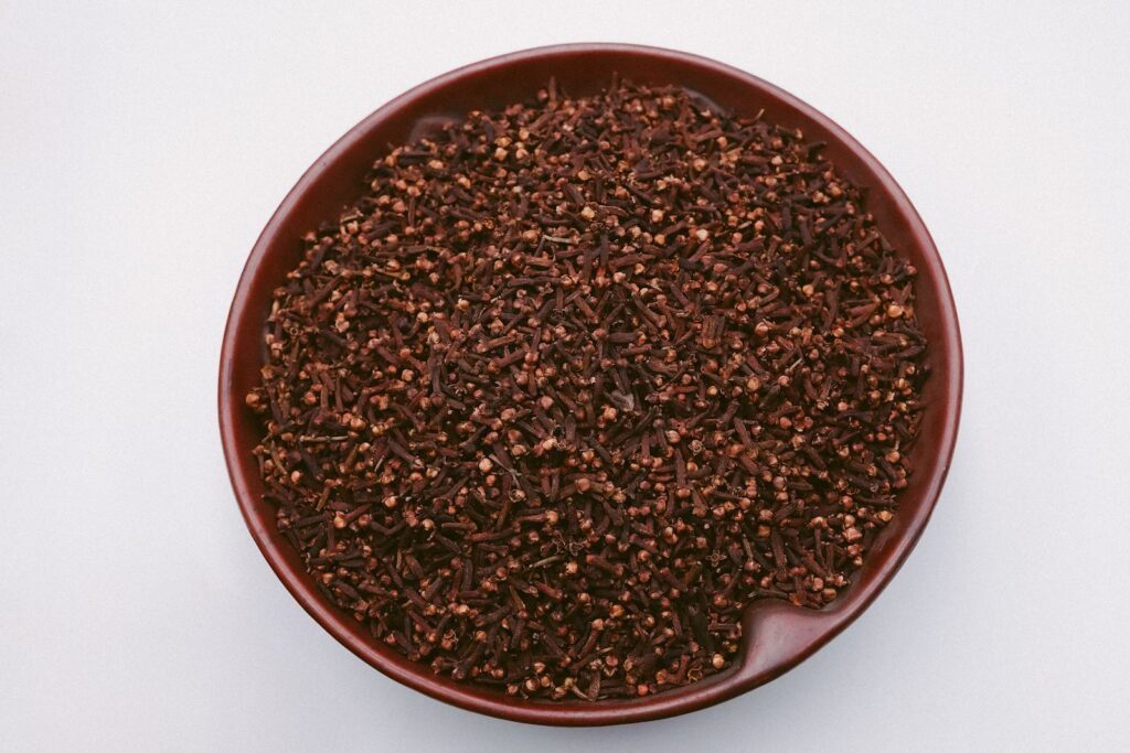 7 Surprising Benefits of Clove Oil for Teeth: Natural Dental Relief and More! 3 brown and black beans on brown ceramic bowl