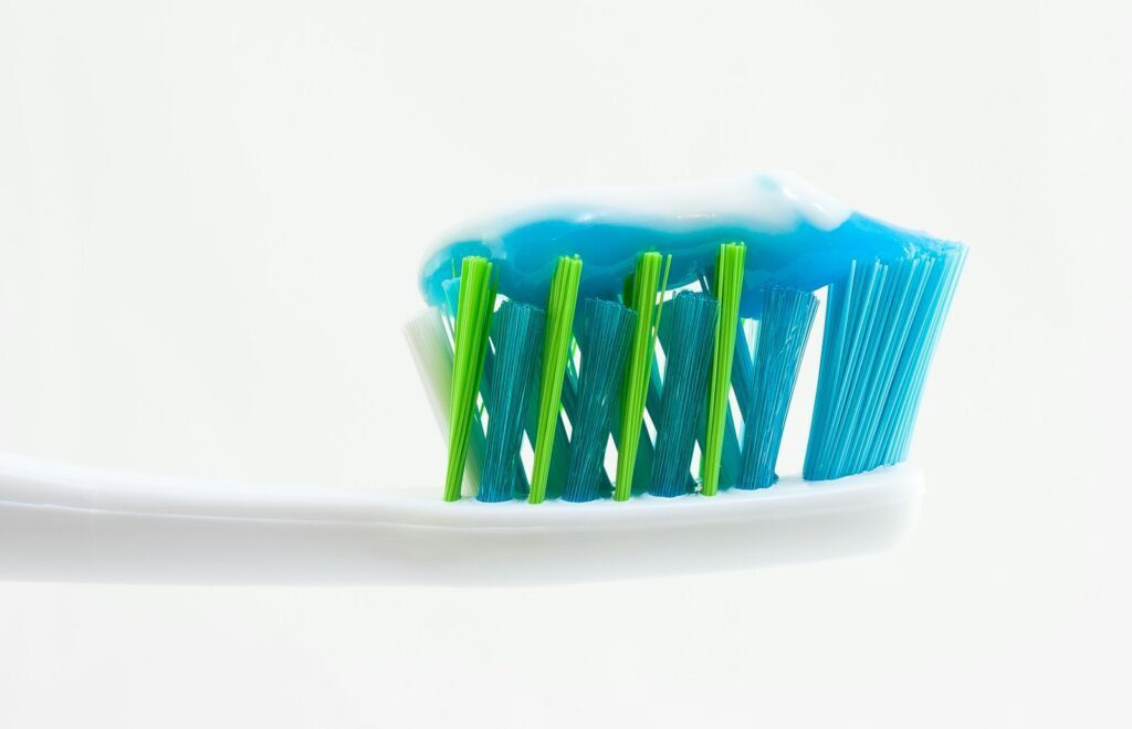 Benefits Of Clove Oil In Toothpaste 2 white, blue, and green toothbrush with blue toothpaste