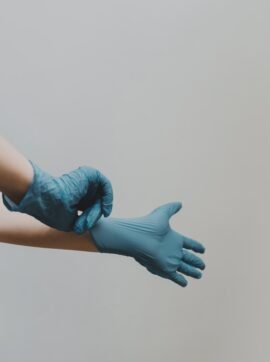 person in blue gloves and blue denim jeans